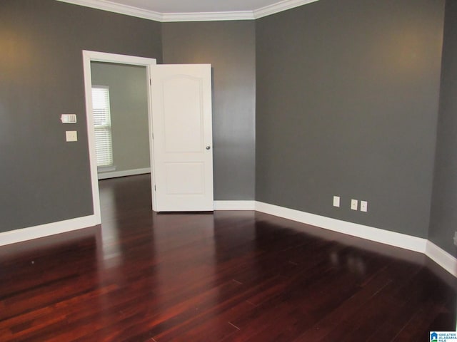 unfurnished room featuring ornamental molding and dark wood-type flooring