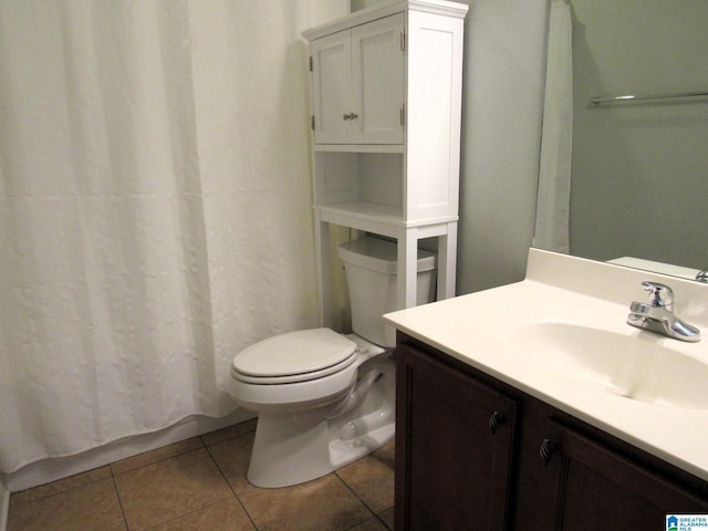 bathroom featuring tile patterned flooring, vanity, a shower with curtain, and toilet