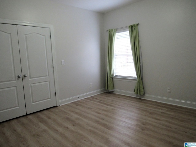 unfurnished bedroom featuring a closet and light hardwood / wood-style flooring