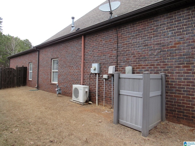 view of side of home featuring ac unit