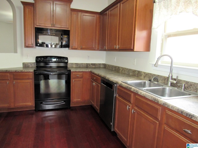 kitchen featuring dark hardwood / wood-style floors, sink, and black appliances