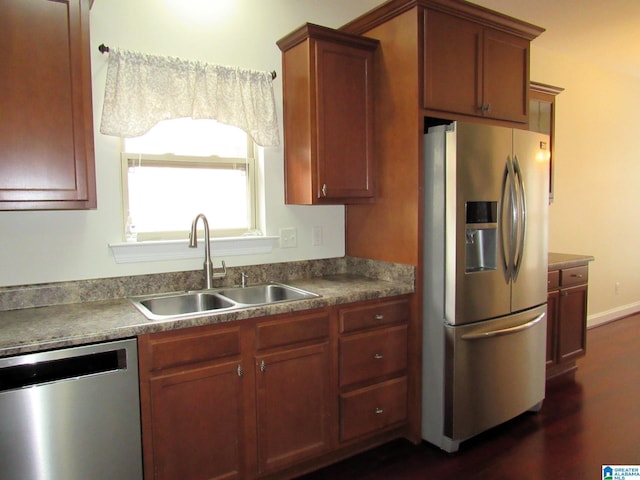 kitchen with stainless steel appliances, sink, and dark hardwood / wood-style flooring