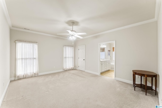 spare room featuring crown molding, visible vents, light carpet, ceiling fan, and baseboards