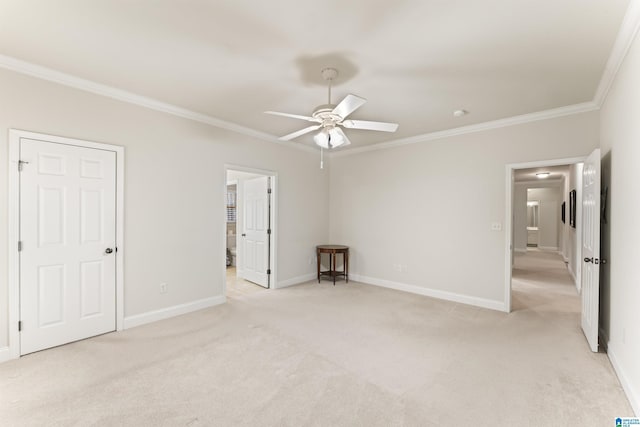 unfurnished bedroom featuring ornamental molding, light carpet, and baseboards