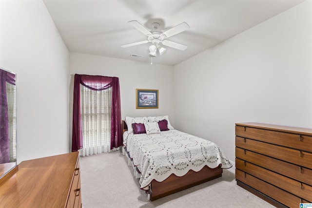 bedroom featuring visible vents, ceiling fan, and carpet flooring