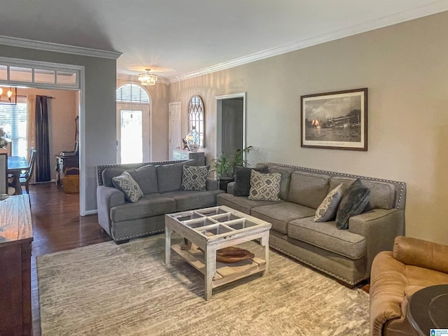 living room with an inviting chandelier, crown molding, and wood-type flooring