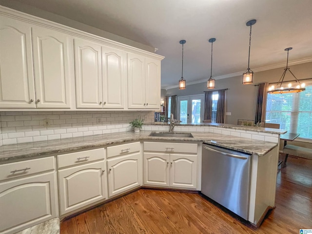 kitchen featuring sink, dishwasher, hanging light fixtures, white cabinets, and kitchen peninsula