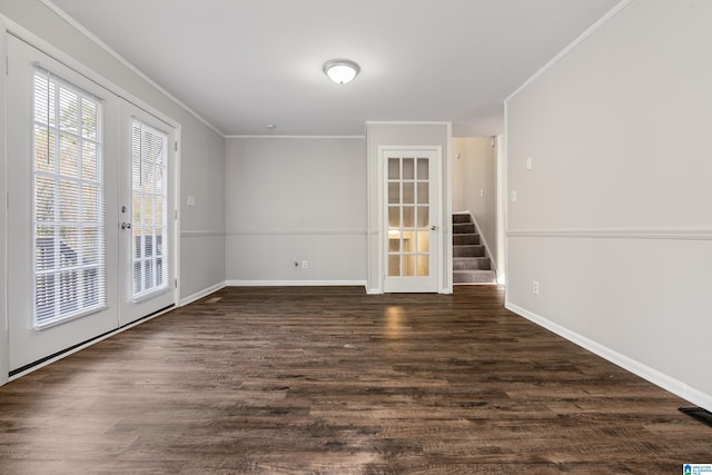 spare room with dark hardwood / wood-style flooring, crown molding, and french doors