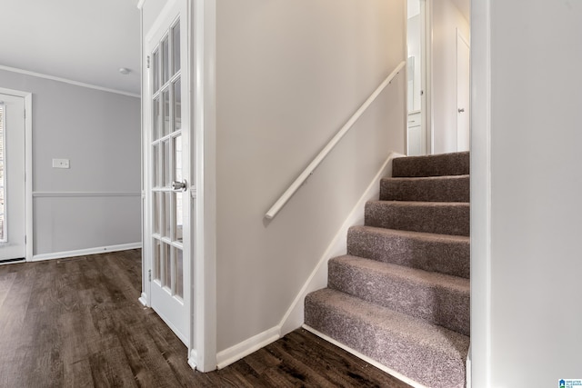 stairs with hardwood / wood-style floors and crown molding