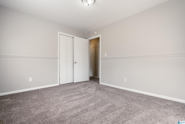 unfurnished bedroom with carpet flooring and a closet