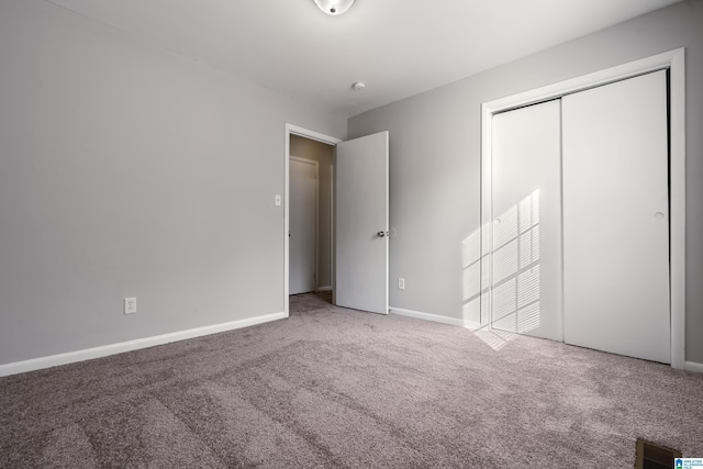 unfurnished bedroom with carpet floors and a closet