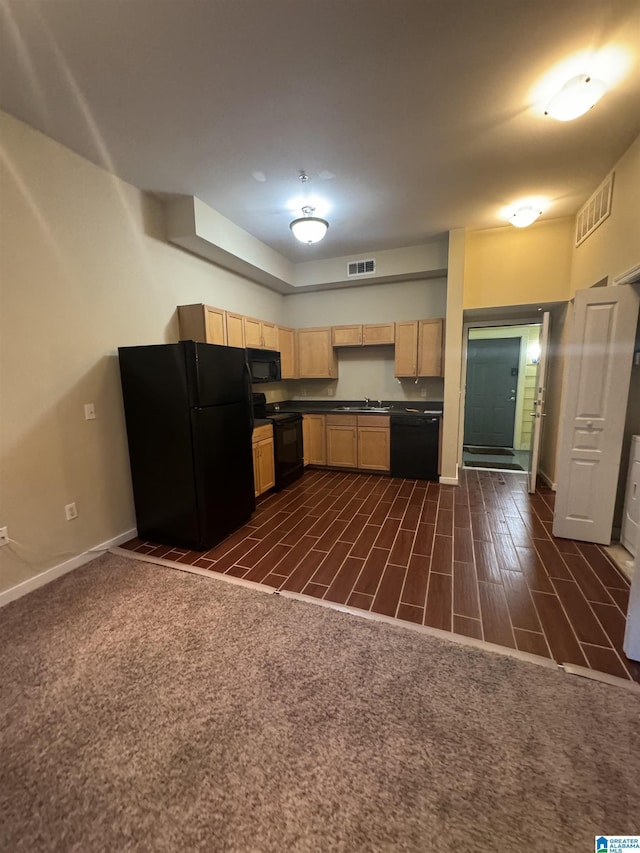 kitchen with dark colored carpet, sink, light brown cabinets, and black appliances