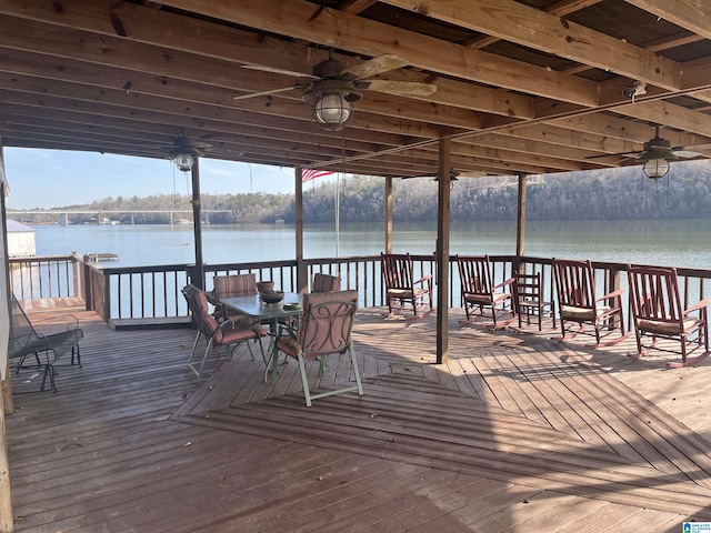 wooden terrace with ceiling fan and a water view