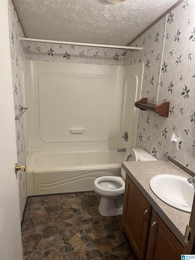 full bathroom featuring vanity, tub / shower combination, a textured ceiling, and toilet