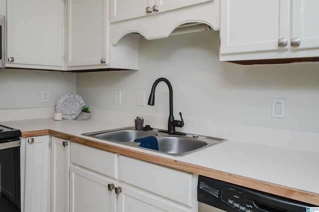 kitchen with white cabinetry, stainless steel appliances, and sink