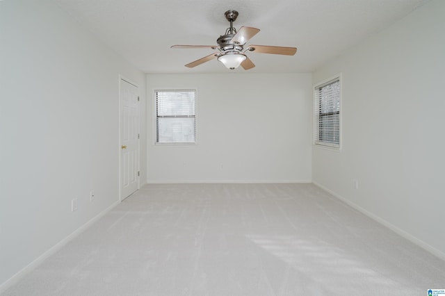 carpeted spare room with a textured ceiling and ceiling fan