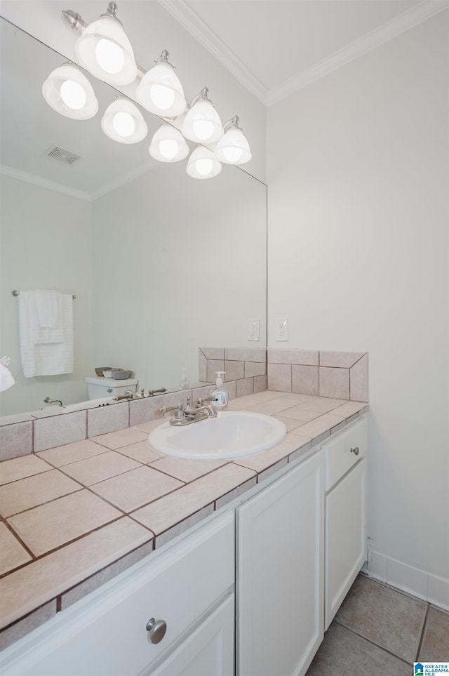 bathroom featuring ornamental molding, tile patterned flooring, and vanity