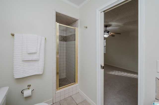 bathroom with walk in shower, ceiling fan, toilet, and crown molding