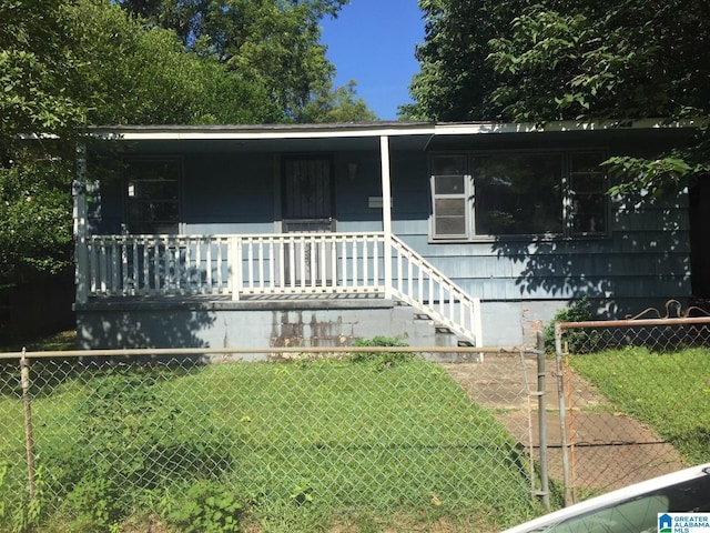 view of front of property with a front yard and covered porch