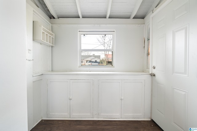 interior space featuring beamed ceiling, dark wood-type flooring, and wooden ceiling