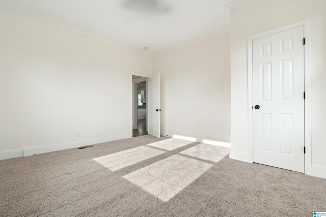 carpeted spare room with crown molding