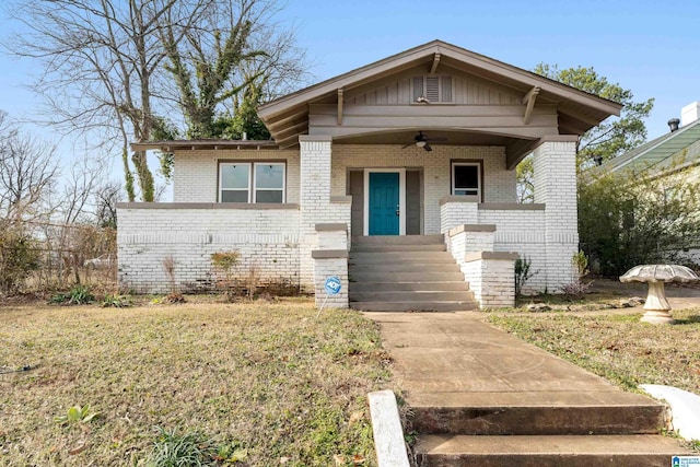 bungalow-style home featuring ceiling fan and a front lawn