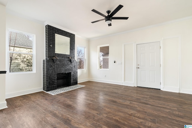 unfurnished living room with ceiling fan, ornamental molding, a fireplace, and dark hardwood / wood-style flooring