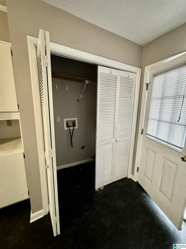 clothes washing area with washer hookup and a textured ceiling