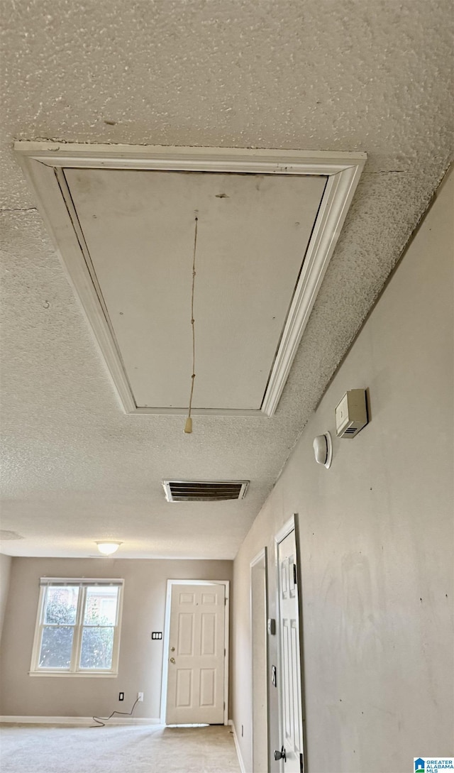 hallway featuring a textured ceiling