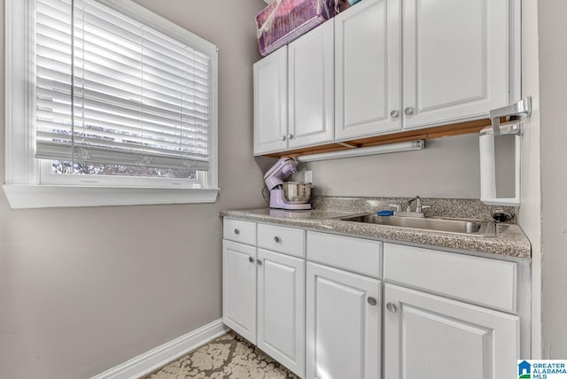 kitchen with white cabinetry and sink