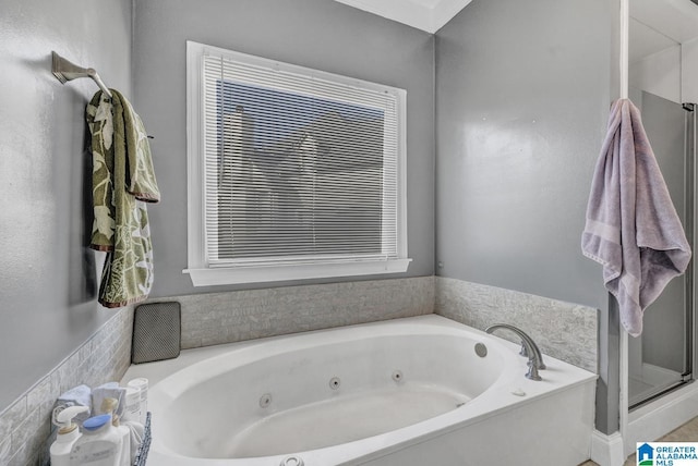 bathroom featuring independent shower and bath