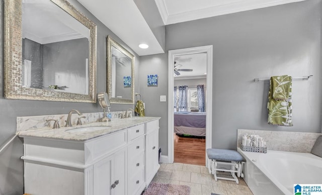 bathroom featuring a tub to relax in, tile patterned flooring, vanity, ceiling fan, and crown molding