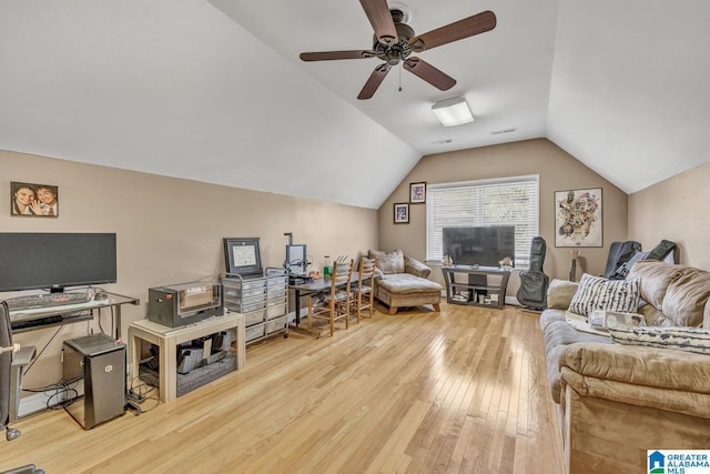 living room with ceiling fan, lofted ceiling, and light hardwood / wood-style flooring