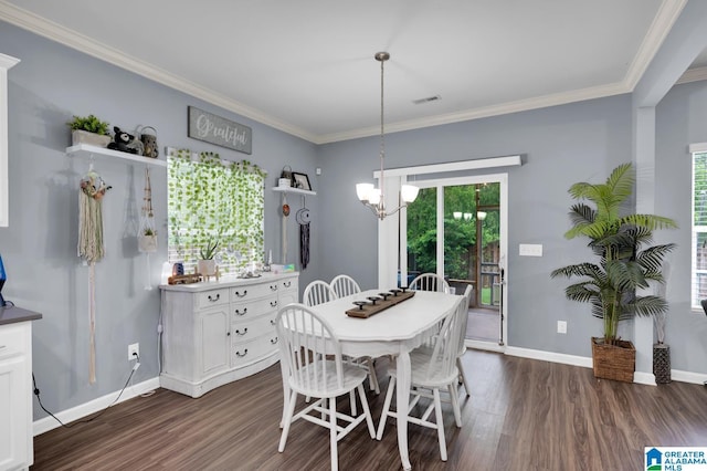 dining area with ornamental molding, dark wood-type flooring, a wealth of natural light, and a notable chandelier