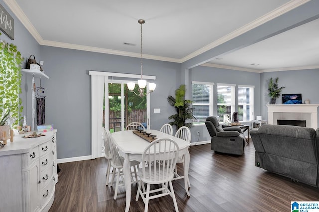 dining space featuring dark hardwood / wood-style flooring, ornamental molding, a fireplace, and an inviting chandelier