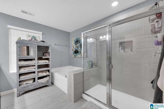 bathroom with separate shower and tub