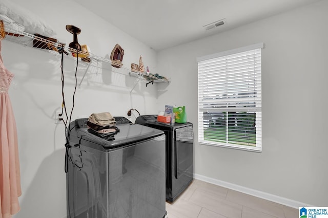 clothes washing area featuring washer and dryer