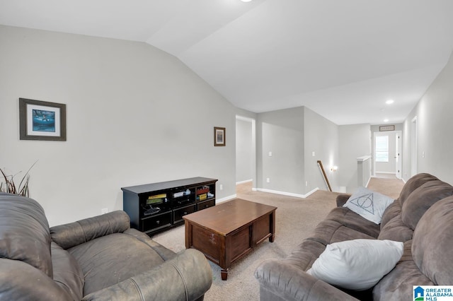 carpeted living room with vaulted ceiling