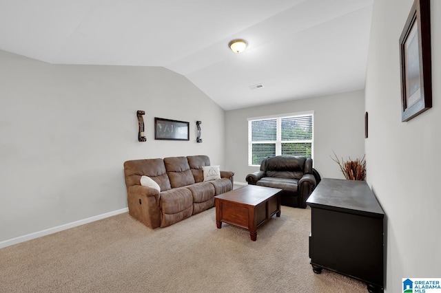 carpeted living room featuring lofted ceiling