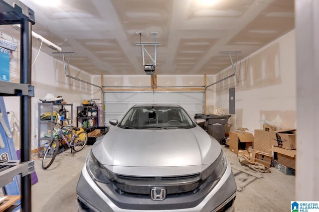 garage with a garage door opener and electric panel