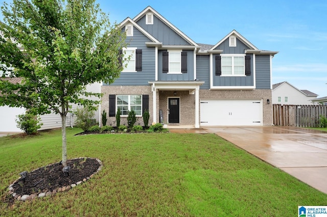 craftsman inspired home featuring a garage and a front lawn