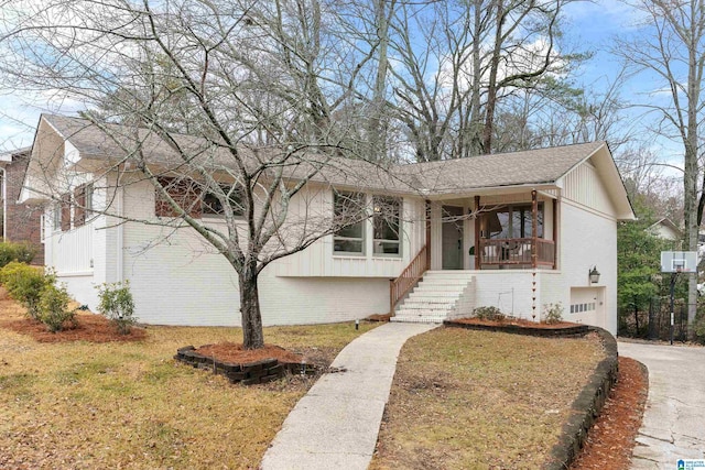 view of front of home featuring a garage, a porch, and a front lawn