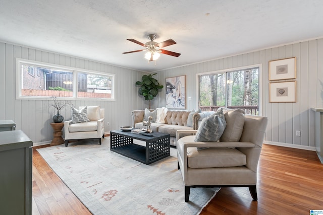 living room featuring hardwood / wood-style floors, a wealth of natural light, and ceiling fan