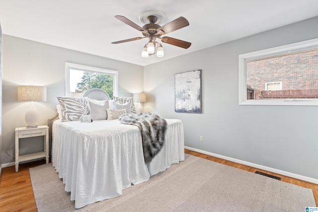 bedroom featuring hardwood / wood-style flooring and ceiling fan