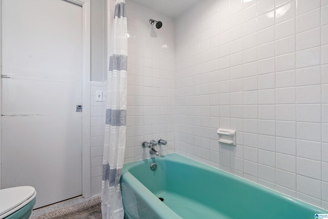 bathroom with shower / bath combination with curtain and toilet