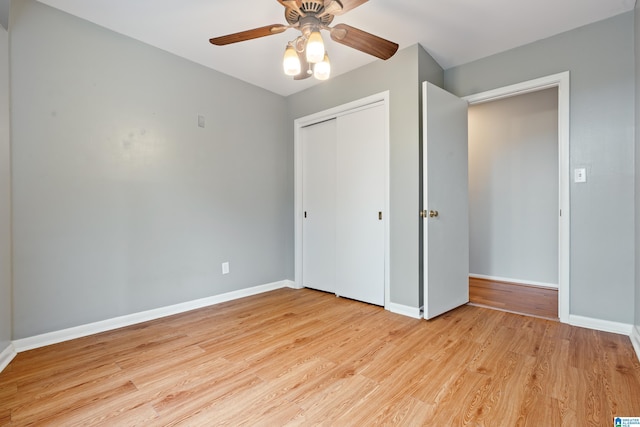 unfurnished bedroom with ceiling fan, a closet, and light wood-type flooring