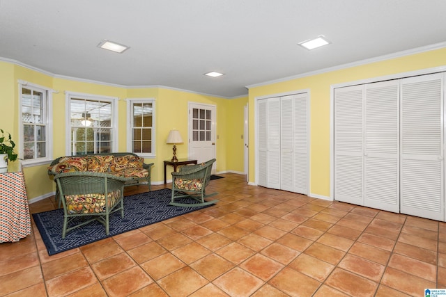 sitting room with crown molding and light tile patterned floors