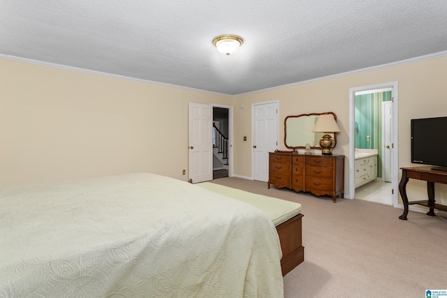 carpeted bedroom featuring crown molding, connected bathroom, and a textured ceiling