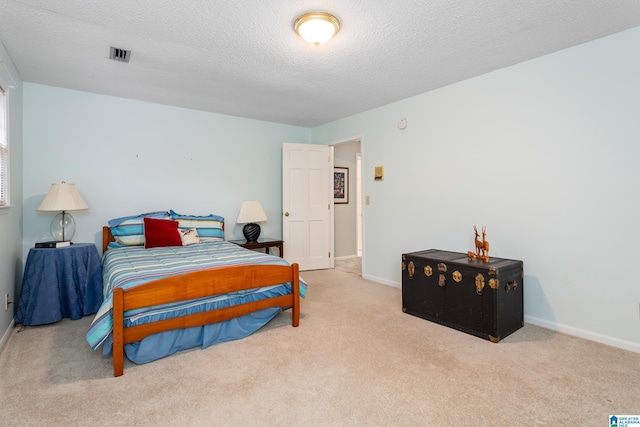 carpeted bedroom featuring a textured ceiling