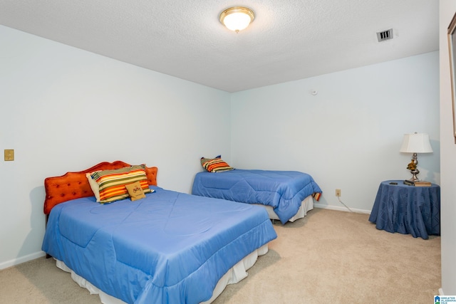 bedroom featuring carpet flooring and a textured ceiling